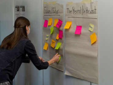 Woman near a board with sticky notes